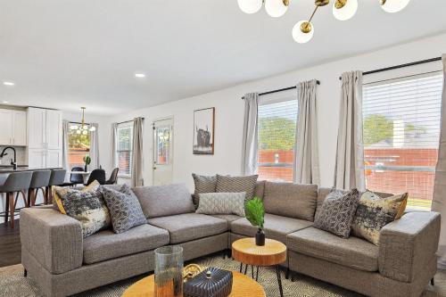 a living room with a couch and a table at Modern Comforts & Classic Charm w Pool 5BD in Saginaw