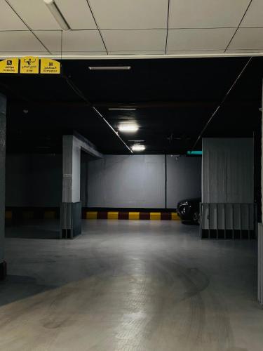 an empty parking garage with a car parked in it at شقق زهرة الباهية للشقق المخدومة in Najran
