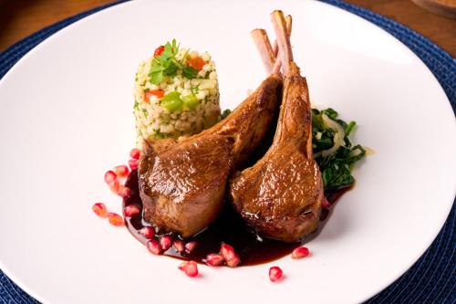 a plate of food with meat and corn on a table at Shore Hotel in Los Angeles