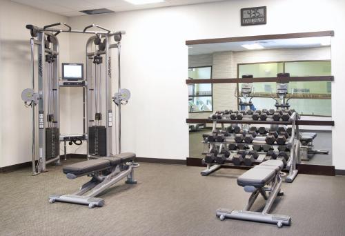 a gym with several tread machines and a mirror at Courtyard by Marriott Seattle Everett Downtown in Everett