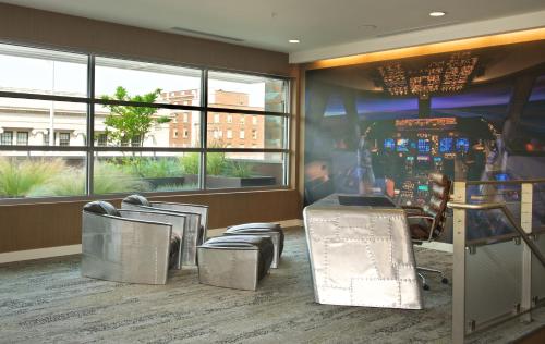 a waiting room with chairs and a pinball machine at Courtyard by Marriott Seattle Everett Downtown in Everett