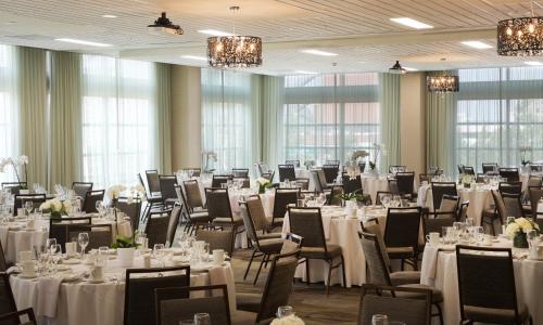 a banquet hall with white tables and chairs at Courtyard by Marriott Seattle Everett Downtown in Everett