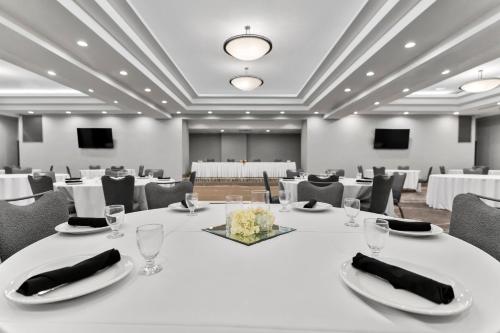 a conference room with white tables and chairs at Holiday Inn Dubuque/Galena by IHG in Dubuque