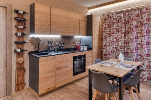 a kitchen with a wooden table and a dining room at La Certosa in Chiusa di Pesio