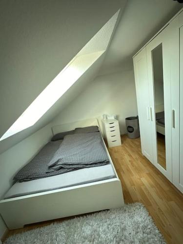 a white room with a bed in a attic at Ferienwohnung im Deister in Springe