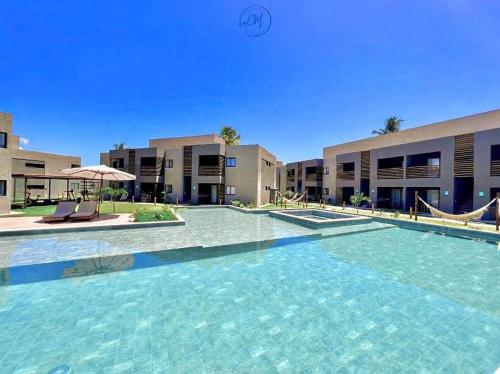 a large swimming pool in front of a building at Flat Patacho - Rota Ecológica dos Milagres in Pôrto de Pedras