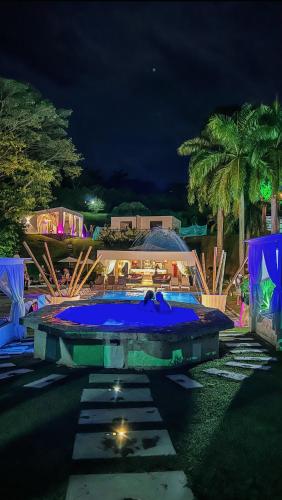 a swimming pool at a resort at night at Dharma Hotel Boutique Spa in San Jerónimo