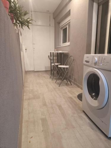 a laundry room with a washer and a table at Apartment Patra Greece in Patra
