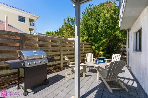a grill and a table and chairs on a patio at Beach Rd, 300ft to Beach Access & 500ft to Siesta Key Village, 2bdr & Studio in Siesta Key