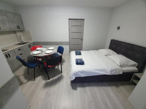 a bedroom with a bed and a table and chairs at HotelRoom 27 in Uzhhorod