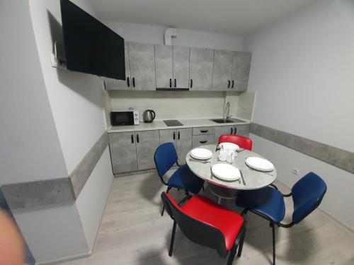 a dining room with a table and chairs and a kitchen at HotelRoom 27 in Uzhhorod