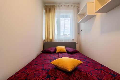 a bedroom with a bed with two pillows on it at Flexible SelfCheckIns 102 - Zagreb - Parking - WIFI - Loggia in Zagreb