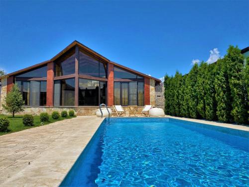 a house with a swimming pool in front of a house at Bloom House in Zovuni