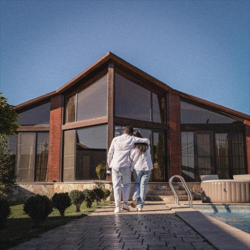 a man standing in front of a house at Bloom House in Zovuni