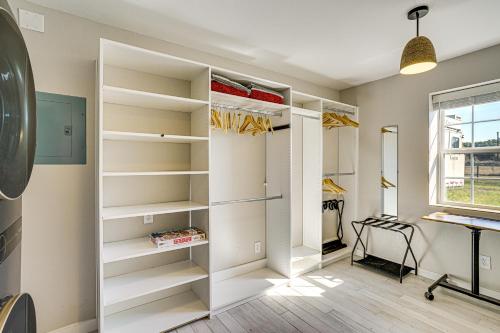 a walk in closet with white shelves and a window at Dog-Friendly Guest House on Horse Ranch in Azle! in Azle