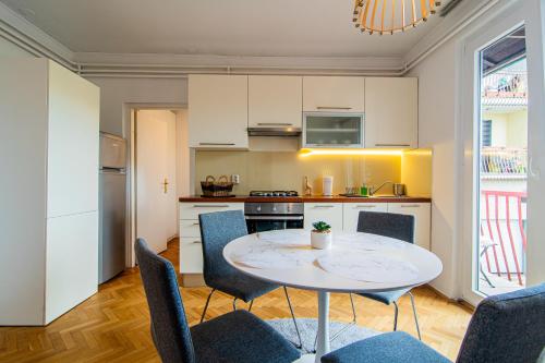 a kitchen and dining room with a table and chairs at Flexible SelfCheckIns 102 - Zagreb - Parking - WIFI - Loggia in Zagreb