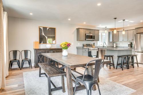 a kitchen and dining room with a wooden table and chairs at Walk to Beaches and Parks Home with Deck in Laconia in Laconia