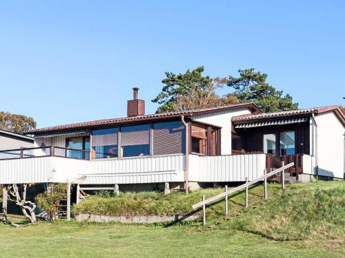 a house with a white fence in front of it at 6 person holiday home in Laholm-By Traum in Laholm
