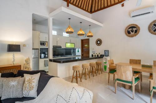 a living room and kitchen with a table and chairs at Villa Nemia Seminyak in Seminyak