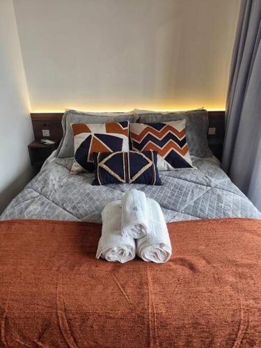 a bed with a towel on top of it at On Paulista - Confort Studio in São Paulo