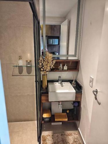 a small bathroom with a sink and a shower at On Paulista - Confort Studio in São Paulo