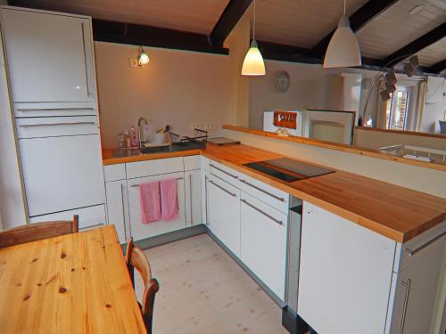 a kitchen with a wooden counter top and a table at Ferienhaus, Krusendorf in Krusendorf
