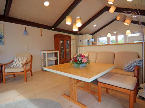 a living room with a table with flowers on it at Ferienhaus, Krusendorf in Krusendorf