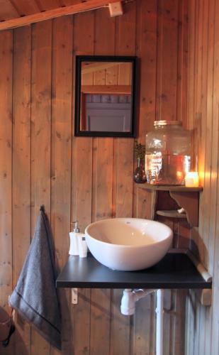 a bathroom with a large white sink on a wall at Cozy cottage with a Wonderful view - Hiking trails - Silence in Mjåvatn