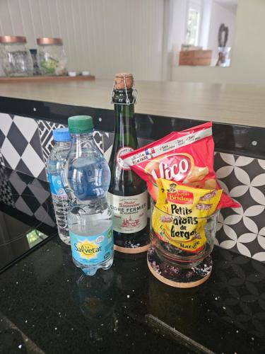 a counter with two bottles of water and some snacks at La Petite Maison Romantique Giverny 5km in Bennecourt