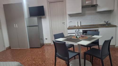 a kitchen with a table and chairs in a room at BAM BAM TIBURTINA Guesthouse in Rome