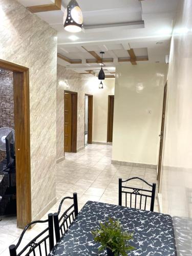 a dining table and chairs in a room with a table and chairsktop at Appartement meublés in Dakar