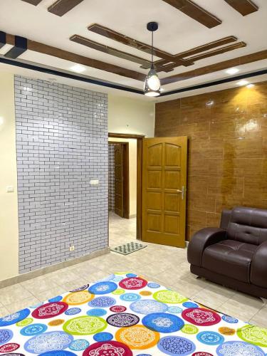 a living room with a couch and a rug on the floor at Appartement meublés in Dakar
