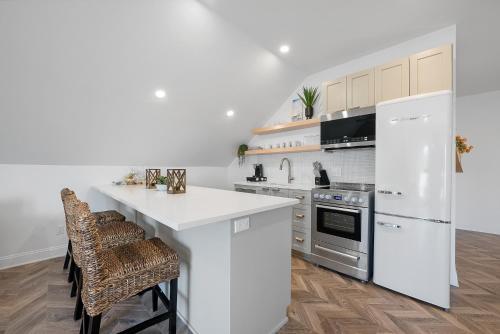 a kitchen with white appliances and a white counter top at The Washington Downtown Boutique Hotel in Sandusky