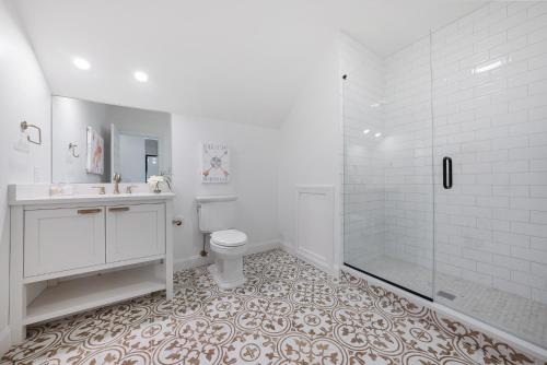 a white bathroom with a toilet and a shower at The Washington Downtown Boutique Hotel in Sandusky