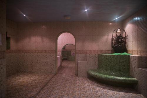 a tiled bathroom with a large tub in a room at Massara House Al Khobar 2 in Al Khobar