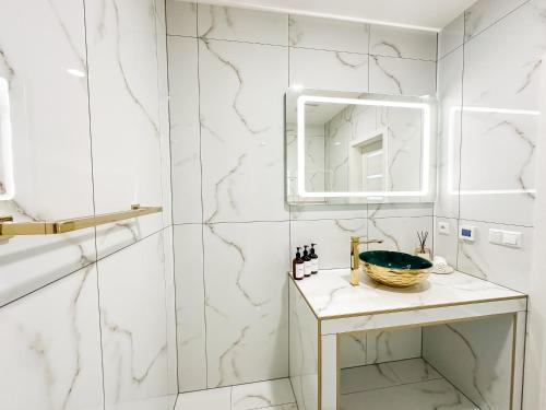 a bathroom with a sink and a mirror at LUX apartments in Central park in Banská Bystrica