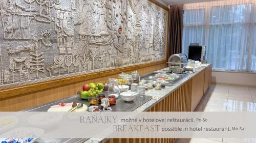 a buffet in a hotel room with food on a counter at LUX apartments in Central park in Banská Bystrica
