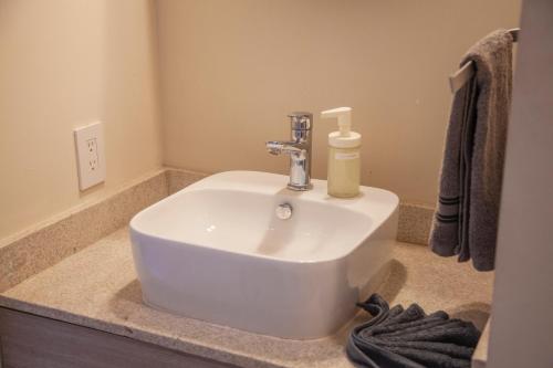 a bathroom sink with a soap dispenser on it at HOTEL BIULÚ in Santa Cruz Huatulco