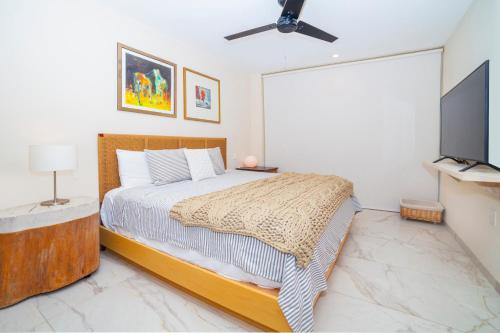 a bedroom with a bed and a flat screen tv at HOTEL BIULÚ in Santa Cruz Huatulco