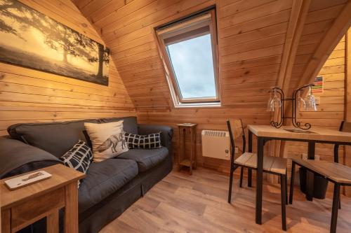 a living room with a couch and a table at Borrett Escapes - Luxury Pods in Sedbergh