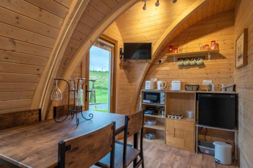 a kitchen with an archway in a tiny house at Borrett Escapes - Luxury Pods in Sedbergh