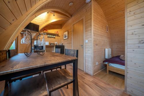 a kitchen with a large wooden table in a room at Borrett Escapes - Luxury Pods in Sedbergh