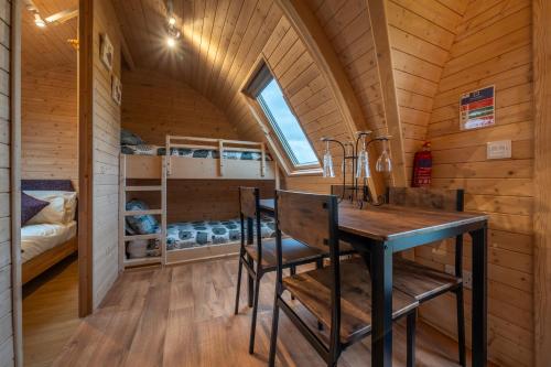 a dining room with a table and chairs in a tiny house at Borrett Escapes - Luxury Pods in Sedbergh