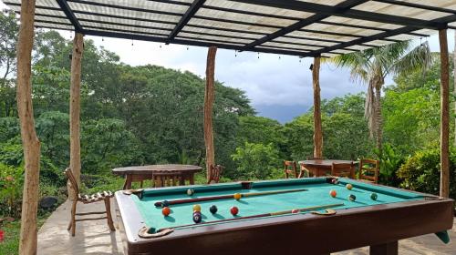 a pool table sitting under a pergola at Eco-Lodge El Porvenir. in Santa Cruz