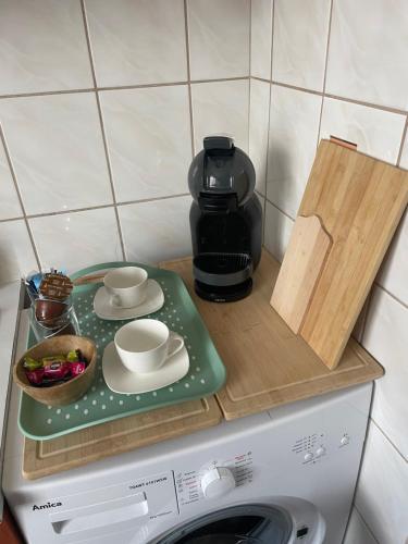a tray on top of a washing machine with a coffee maker at Tiny Studio Pyskowice with parking in Pyskowice