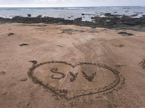 a heart drawn in the sand on a beach at Hostal Portobelo in Portobelo