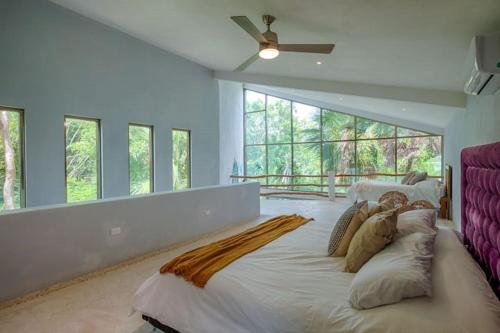a large bedroom with a large bed with a large window at Casa Luna in Bacalar