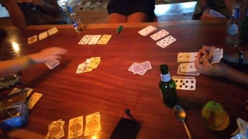 two people playing a game of cards on a table at Hostal Portobelo in Portobelo