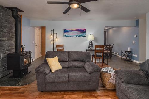 a living room with a couch and a wood stove at Cozy City Stay, 3bdrm near Airport in Anchorage