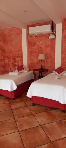Ένα ή περισσότερα κρεβάτια σε δωμάτιο στο Casa Mia Hotel